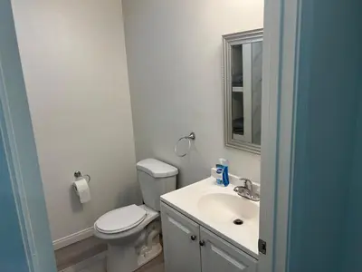 a bathroom with a toilet and a sink and a mirror at Modern and charming 1 bed first floor apartment in La Mesa