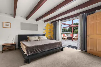 a bedroom with a bed and a door to a patio at Boho-Style Point Loma Retreat Large Outdoor Deck in San Diego