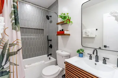 a bathroom with a sink and a toilet and a mirror at Gorgeous 2bd 2ba House - Balboa Park Zoo Downtown in San Diego