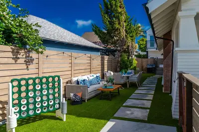 a backyard with a couch and chairs on the grass at Gorgeous 2bd 2ba House - Balboa Park Zoo Downtown in San Diego
