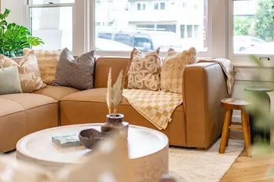 a living room with a brown couch and a table at Gorgeous 2bd 2ba House - Balboa Park Zoo Downtown in San Diego