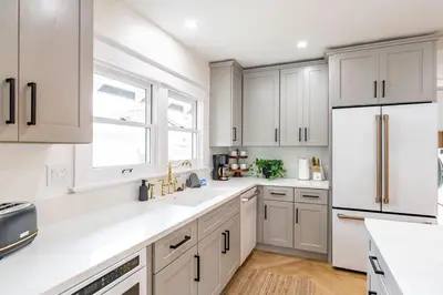 a kitchen with white cabinets and a white refrigerator at Gorgeous 2bd 2ba House - Balboa Park Zoo Downtown in San Diego