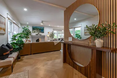 a living room with a large mirror and a couch at Gorgeous 2bd 2ba House - Balboa Park Zoo Downtown in San Diego