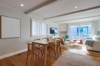 a dining room and living room with a table and chairs at The Shores 8 in San Diego