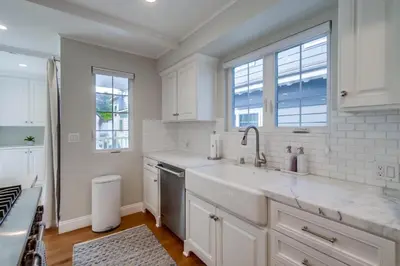 a white kitchen with a sink and a window at The Shores 8 in San Diego