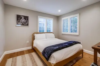 a bedroom with a bed and two windows at The Shores 8 in San Diego