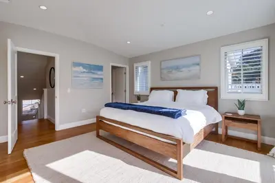 a bedroom with a large bed and two windows at The Shores 8 in San Diego