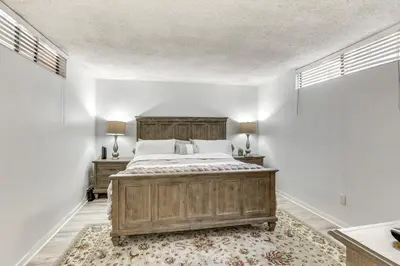 a bedroom with a large wooden bed and two lamps at Waterfront Condo with Dock Access in Carlsbad! in Carlsbad