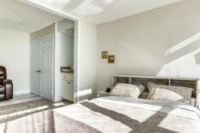 a bedroom with a large bed and a closet at Waterfront Condo with Dock Access in Carlsbad! in Carlsbad