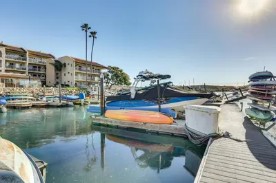 a dock with boats docked in a marina at Waterfront Condo with Dock Access in Carlsbad! in Carlsbad