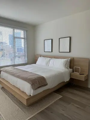 a bedroom with a large bed and a large window at San Diego Skyline in San Diego