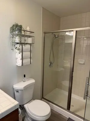 a bathroom with a toilet and a glass shower at San Diego Skyline in San Diego