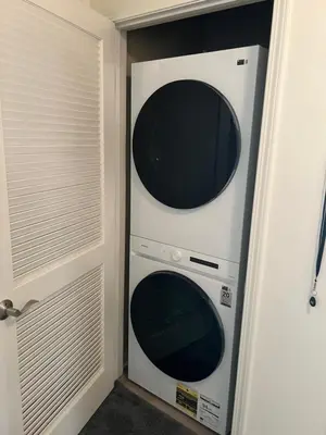 two microwaves sitting in a closet next to a door at San Diego Skyline in San Diego