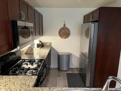 a kitchen with a stove and a refrigerator at San Diego Skyline in San Diego