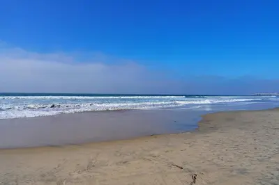 a sandy beach with the ocean in the background at Ocean Front Walk in San Diego