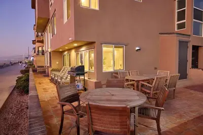 a patio with tables and chairs on a building at Ocean Front Walk in San Diego