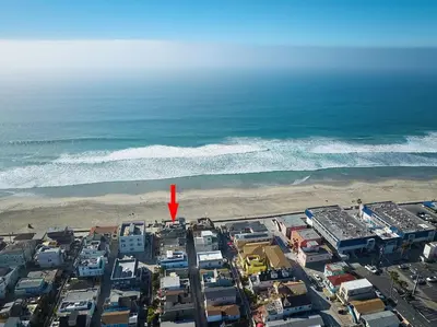 an aerial view of a beach with a red arrow at Ocean Front Walk in San Diego