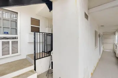 a staircase in a white room with a window at Cozy Couples Escape! Walk to San Clemente Pier in San Clemente