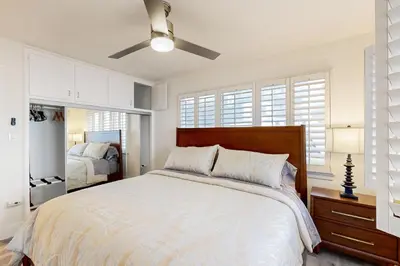 a bedroom with a large bed and a ceiling fan at Cozy Couples Escape! Walk to San Clemente Pier in San Clemente