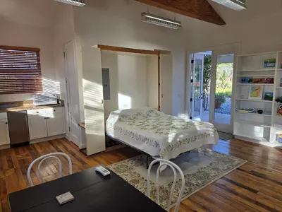 a living room with a bed and a table at Relaxing Countryside Resort Guest House in Poway