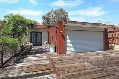 a house with a garage on a wooden deck at Laguna Beach Best Kept Secret Complete Ocean View in Laguna Beach