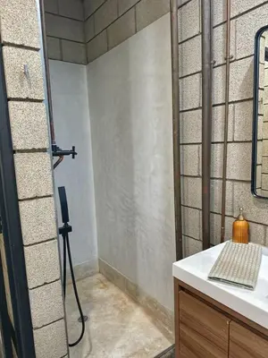 a bathroom with a shower with a sink and a mirror at Laguna Beach Best Kept Secret Complete Ocean View in Laguna Beach
