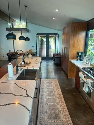 a kitchen with marble counter tops and a kitchen with a sink at Laguna Beach Best Kept Secret Complete Ocean View in Laguna Beach