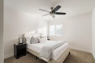 a white bedroom with a ceiling fan and a bed at Stunning Private Resort with Pool in San Marcos