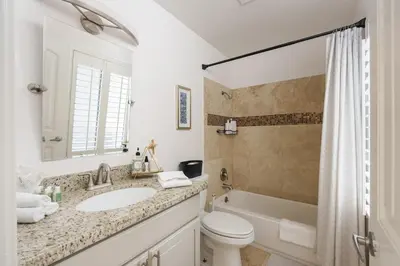 a bathroom with a sink and a toilet and a tub at Stunning Private Resort with Pool in San Marcos