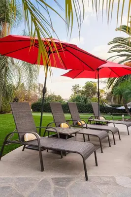 a row of chairs with red umbrellas at Stunning Private Resort with Pool in San Marcos