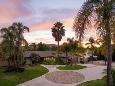 a house with palm trees and a driveway at Stunning Private Resort with Pool in San Marcos