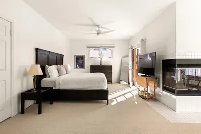 a white bedroom with a bed and a fireplace at Encinitas Retreat Private Pool and Spa Short Drive to Beach in Encinitas