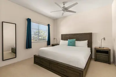 a bedroom with a large bed and a mirror at Encinitas Retreat Private Pool and Spa Short Drive to Beach in Encinitas