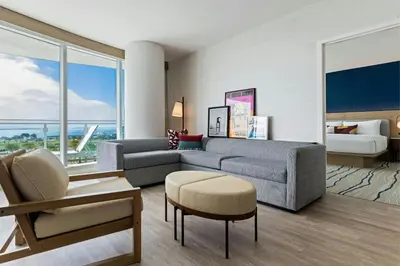 a living room with a couch and a bed at Gaylord Pacific Resort & Convention Center in Chula Vista