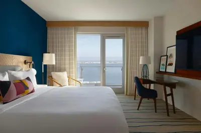 a hotel room with a bed and a desk and window at Gaylord Pacific Resort & Convention Center in Chula Vista