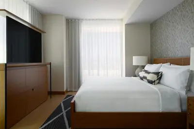 a bedroom with a large white bed and a window at Gaylord Pacific Resort & Convention Center in Chula Vista