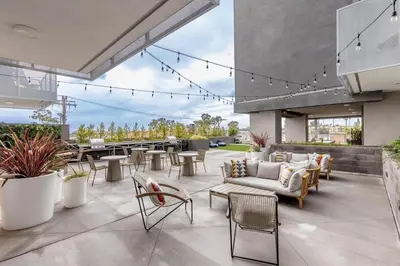 a patio with chairs and tables on a building at Eclectic Fast Wi-Fi Parking Pets Bohemian in San Diego