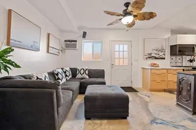 a living room with a couch and a ceiling fan at Next to Downtown Huge yard with Parking in San Diego