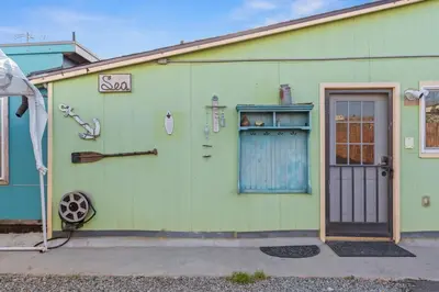 a green house with a door and a window at Next to Downtown Huge yard with Parking in San Diego