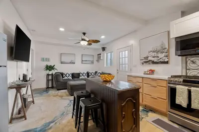 a kitchen and living room with a couch and a table at Next to Downtown Huge yard with Parking in San Diego
