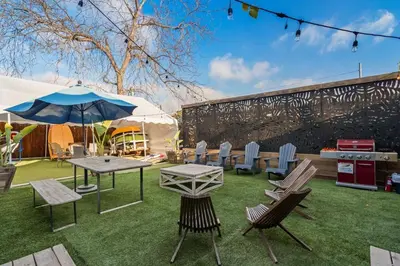 a patio with a table and chairs and an umbrella at Next to Downtown Huge yard with Parking in San Diego