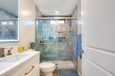 a bathroom with a shower with a toilet and a sink at Newly Remodeled Home in Escondido