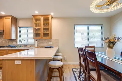 a kitchen with a island with chairs and a counter top at Newly Remodeled Home in Escondido
