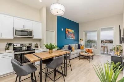 a kitchen and living room with a table and chairs at Artistic FastWiFi Parking Pets in San Diego