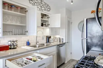a kitchen with white cabinets and a sink at Coastal Escape King 1Bd, Pets Parking Fast Wi-Fi in San Clemente