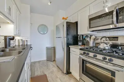 a kitchen with a stove and a refrigerator at Coastal Escape King 1Bd, Pets Parking Fast Wi-Fi in San Clemente