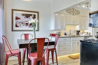 a kitchen with a table and four red chairs at Coastal Escape King 1Bd, Pets Parking Fast Wi-Fi in San Clemente
