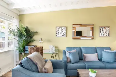 a living room with a blue couch and a table at Gorgeous Retreat Close to Beach and Downtown in San Clemente