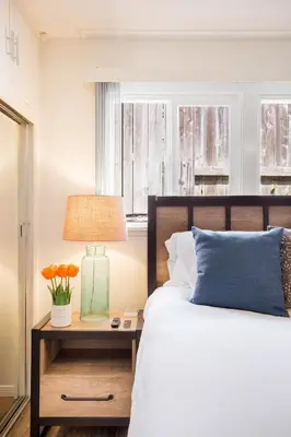 a bedroom with a bed and a table with a lamp at Gorgeous Retreat Close to Beach and Downtown in San Clemente