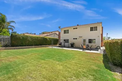 a yard with a house and a hedge at Fun Family Retreat Games, Massage Chair & Yard in Mission Viejo